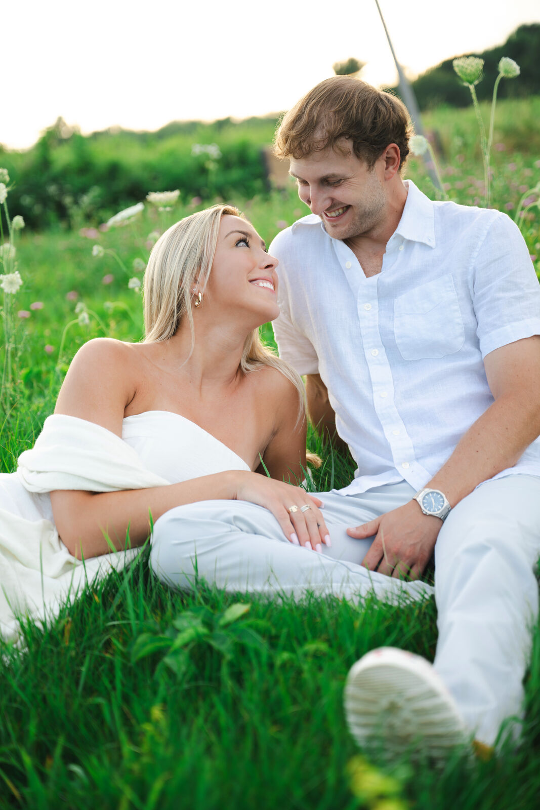 Couple laughing together in a wildflower meadow