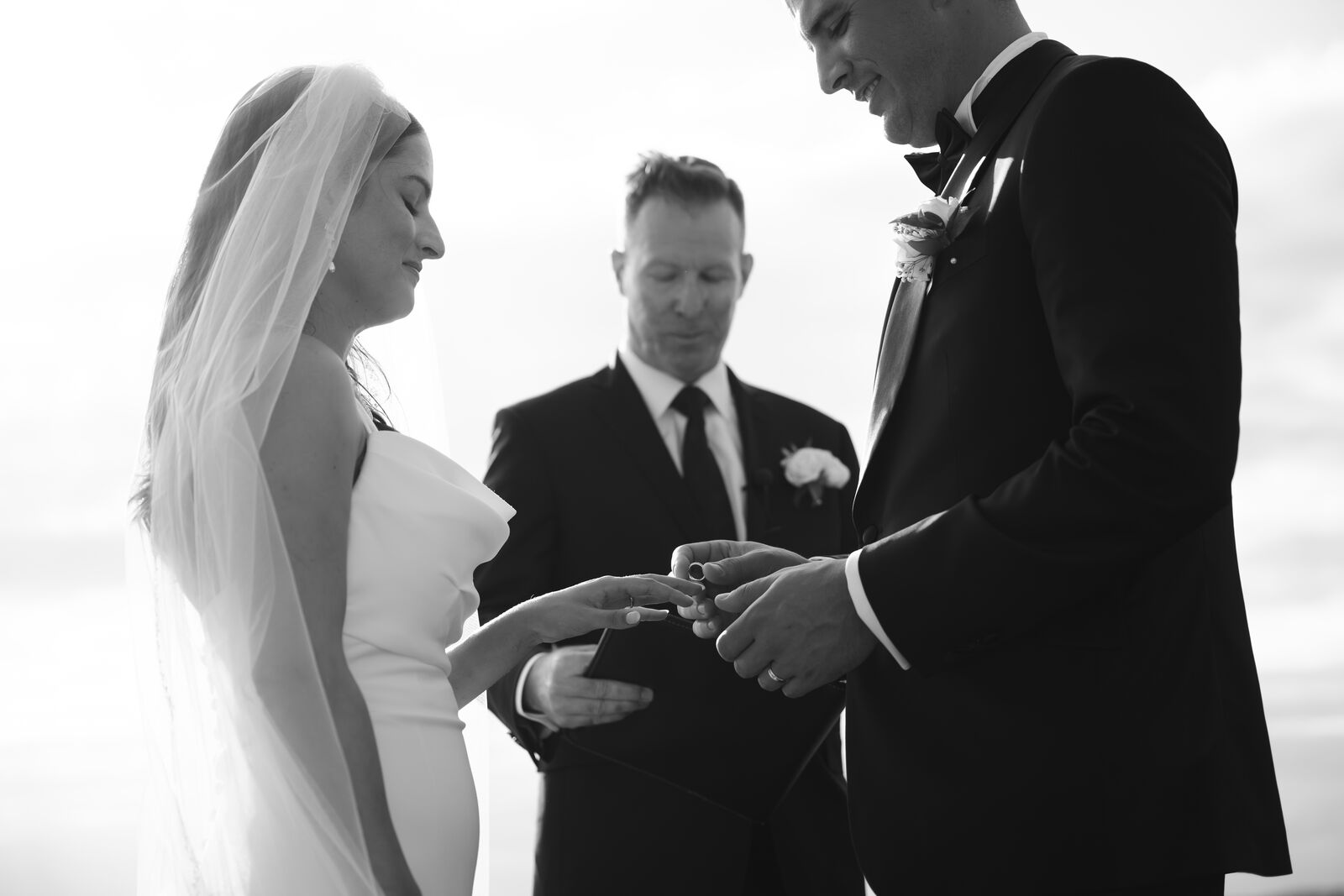 Exchanging rings during an intimate ceremony, black and white