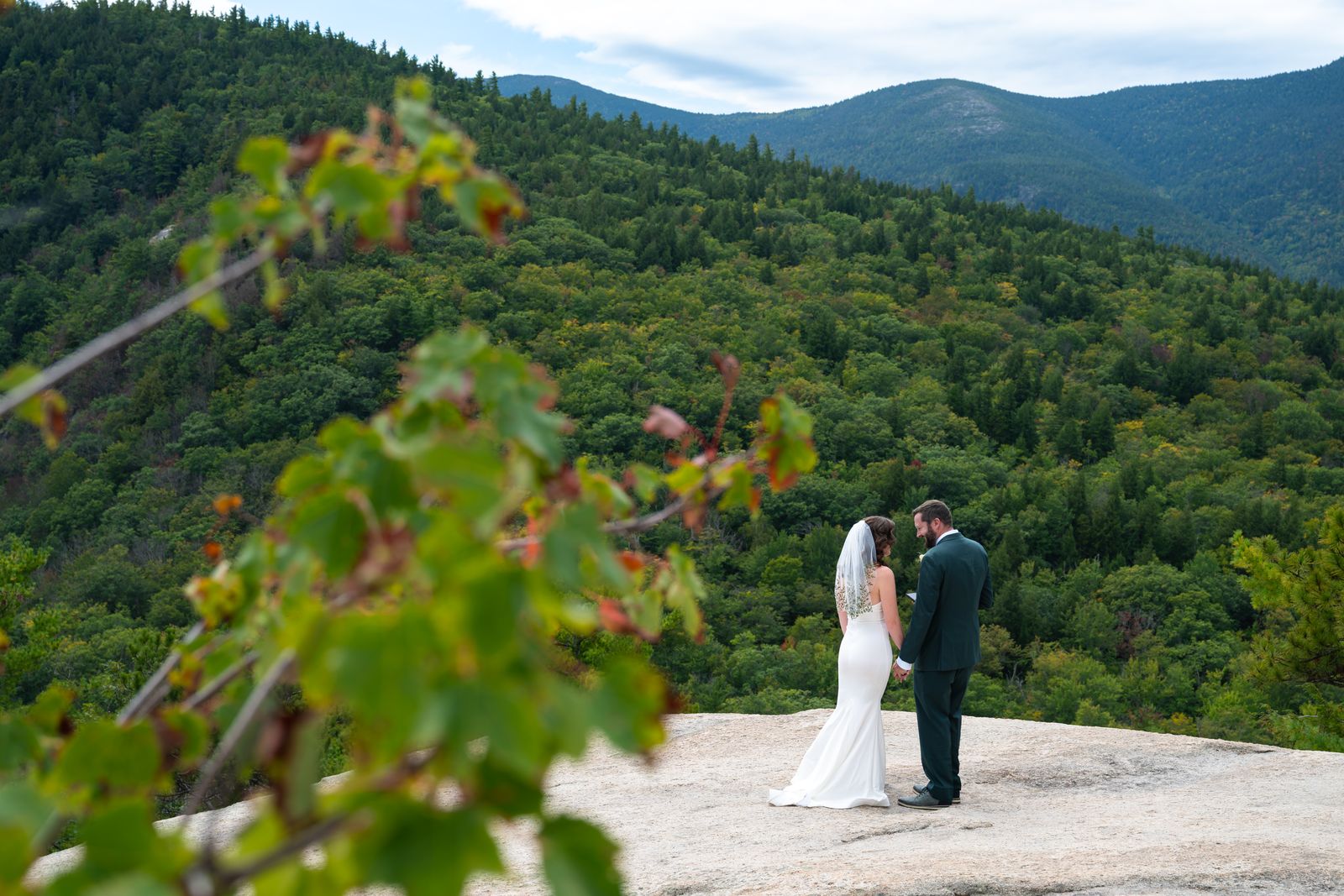 Couple exchanging private vows on the edge of Cathedral Ledge above the Mount Washington Valley